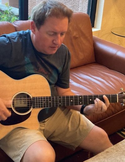 musician kevin stroud playing an acoustic Martin guitar and writing a song