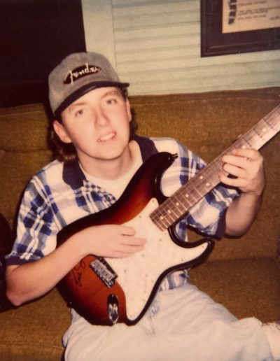 Vintage picture of songwriter Kevin Stroud with electric Fender Stratocaster signed by legendary blues artist Eric Johnson.