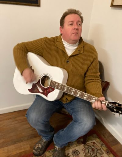Kevin with white Epiphone Dove acoustic guitar